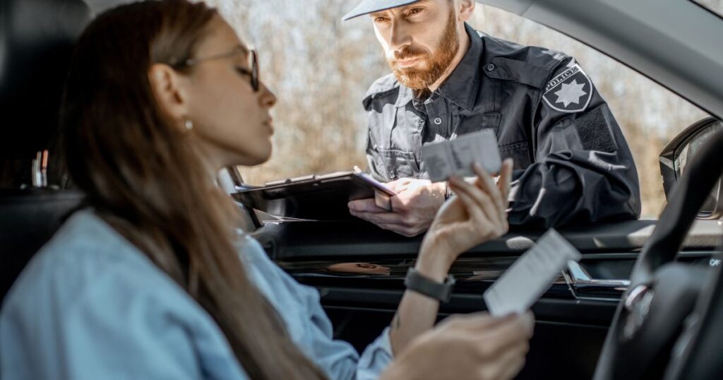 police officer writing a ticket to a motorist
